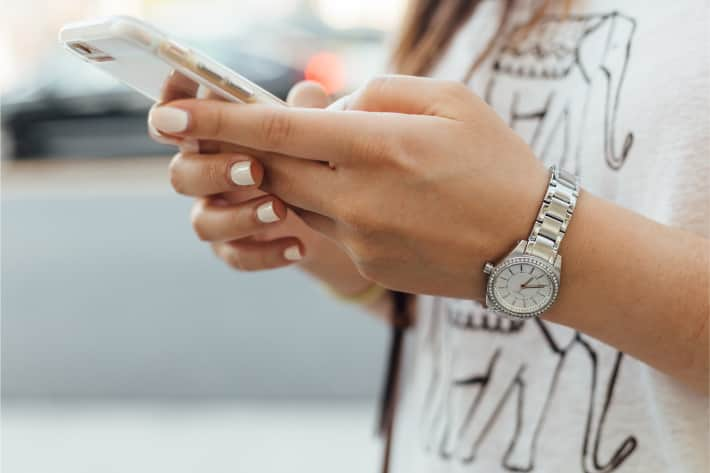 A woman searching for iPhone viruses on her iPhone.